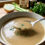 A close-up of a white bowl filled with creamy chestnut soup.